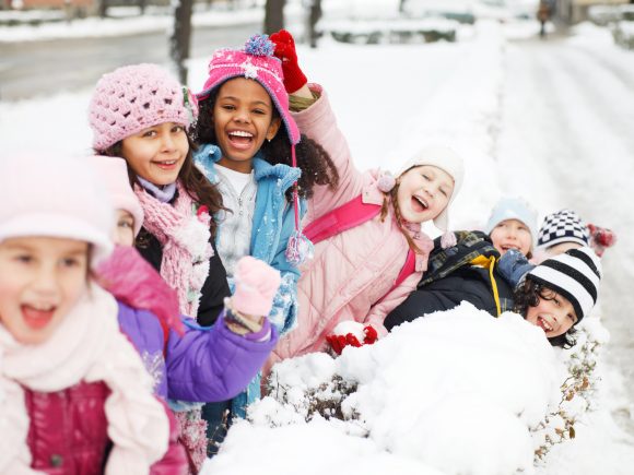 Large group of children having fun in the snow.